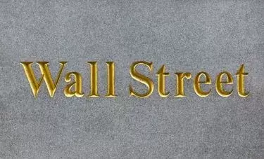 Autodesk class action lawsuit: Wall Street in gold letters on brick background
